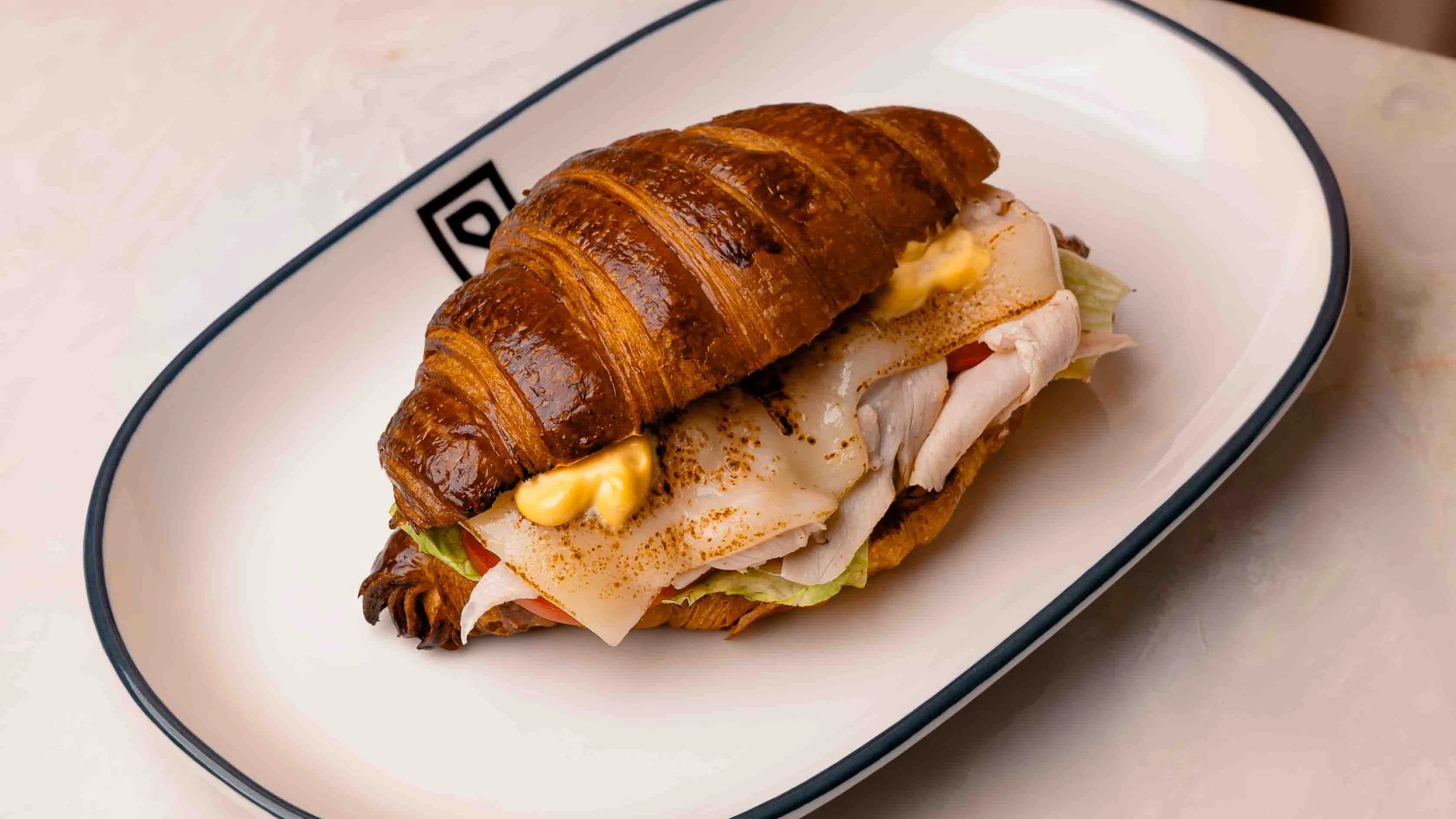 Croissant with turkey and scrambled eggs